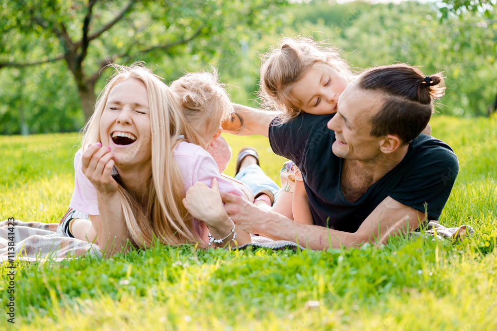 Family lying on grass in countryside Family lying on grass in countryside