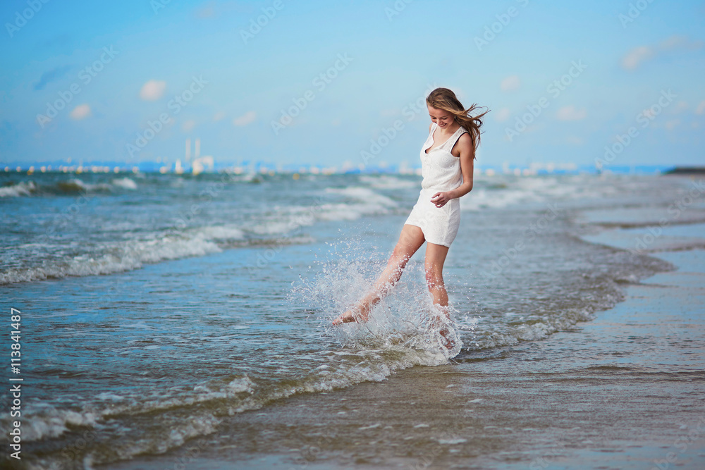 Fototapeta premium Beautiful young woman enjoying her vacation by ocean or sea
