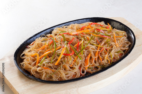 crystal noodles with vegetables in a pan isolated cast iron wok