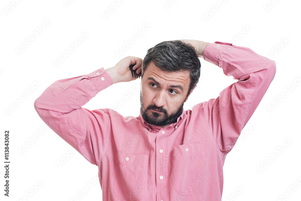 Handsome young beard man combing his hair Handsome young beard man combing his hair