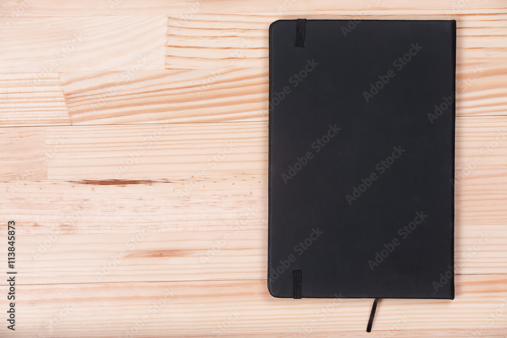 Elegant business black notepad light wooden natural background t Elegant business black notepad light wooden natural background t