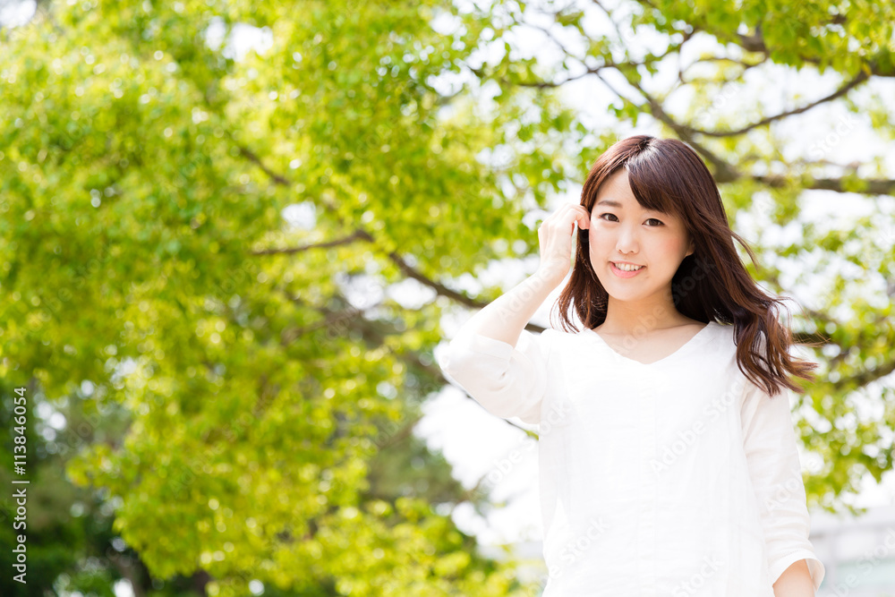 young asian woman relaxing in the park young asian woman relaxing in the park