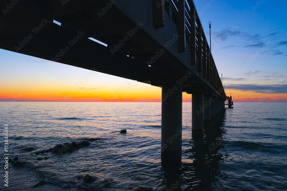 Long sea pier at sunset