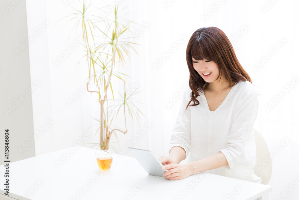 attractive asian woman using tablet computer