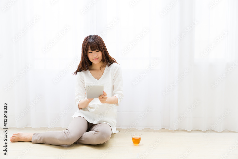attractive asian woman using tablet computer attractive asian woman using tablet computer