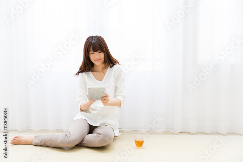 Free Download attractive asian woman using tablet computer - GFXLoad