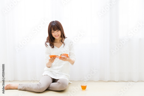 attractive asian woman reading book