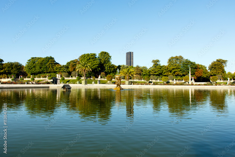 Wide angle view of pond in Luxembourg Gardens, Paris, France, with the Montparnesse Tower in the background. Horizontal with copy space for text Wide angle view of pond in Luxembourg Gardens, Paris, France, with the Montparnesse Tower in the background. Horizontal with copy space for text