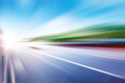 Abstract image of traffic lights in motion blur on the street.