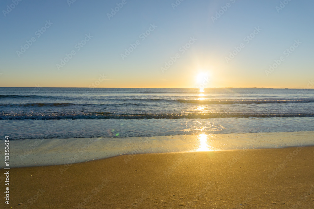 Papamoa Beach, outlok to horizon beautiful golden glow into sunrise