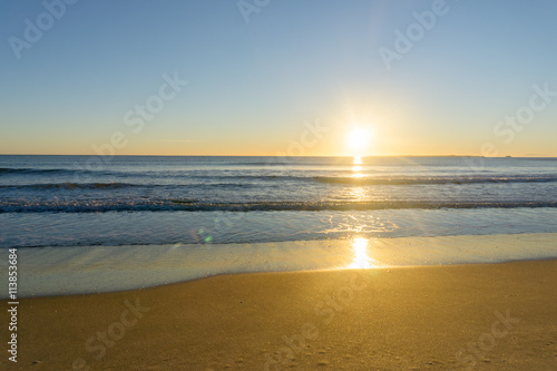 Fototapeta Naklejka Na Ścianę i Meble -  Papamoa Beach, outlok to horizon beautiful golden glow into  sunrise