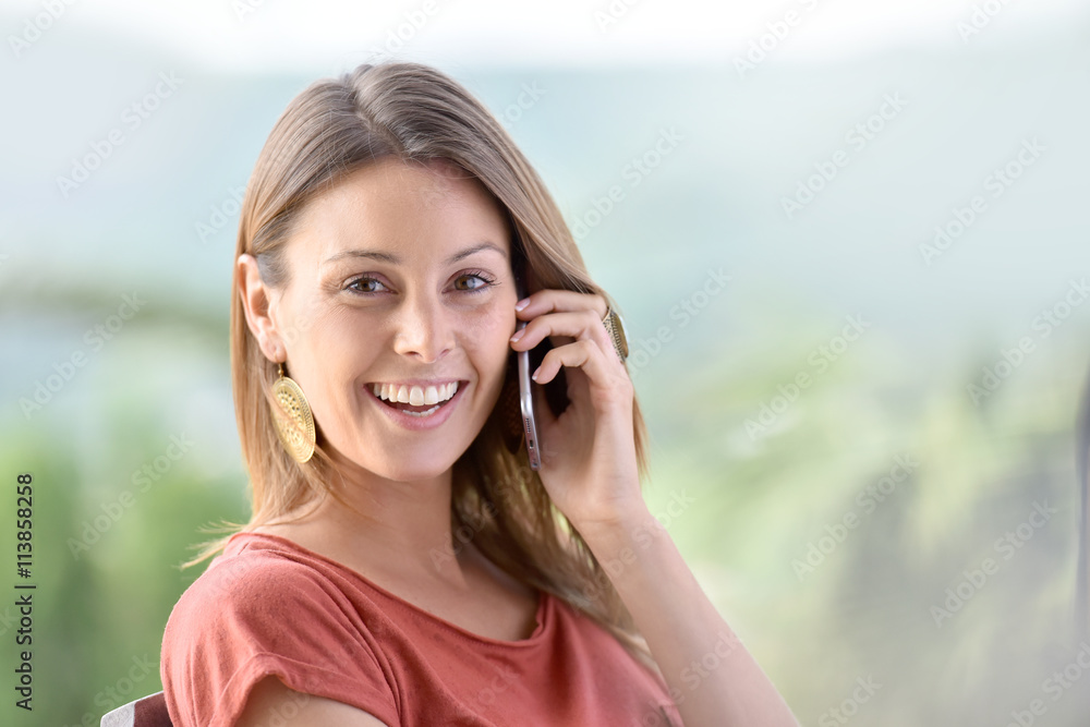 Beautiful woman in garden talking on phone Beautiful woman in garden talking on phone
