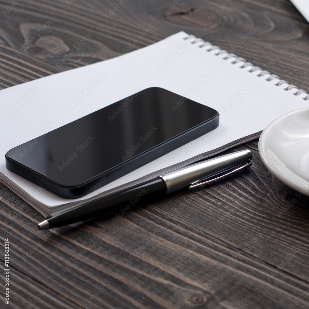 Office work place with smartphone and notebook Office work place with smartphone and notebook