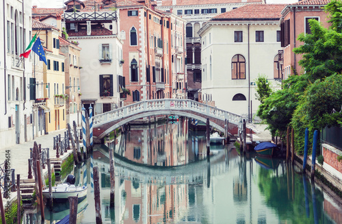 Bridge over canal in Venice, Italy. Traditional architecture also reflected in the water
