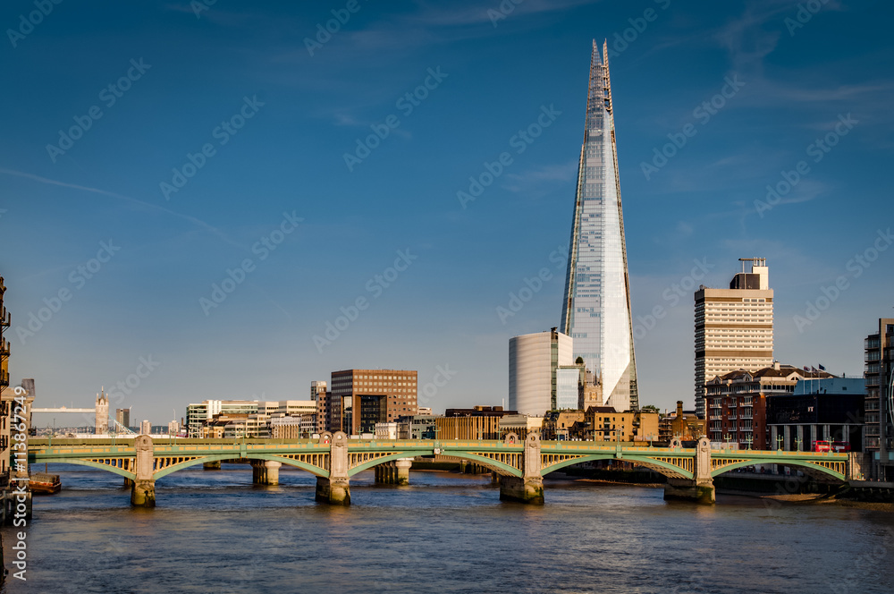 London’s south bank seen from the Millennium Bridge with London Bridge, Tower Bridge and river Thames at golden hour