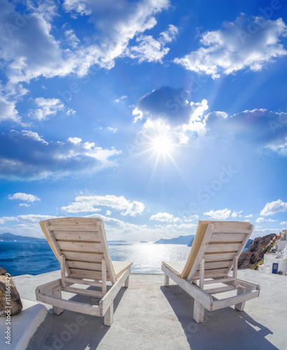 Oia village with sunbeds on Santorini island in Greece