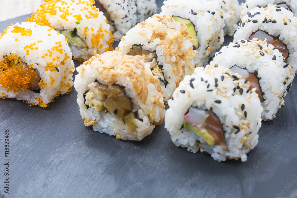 Sushi rolls on a slate plate Sushi rolls on a slate plate