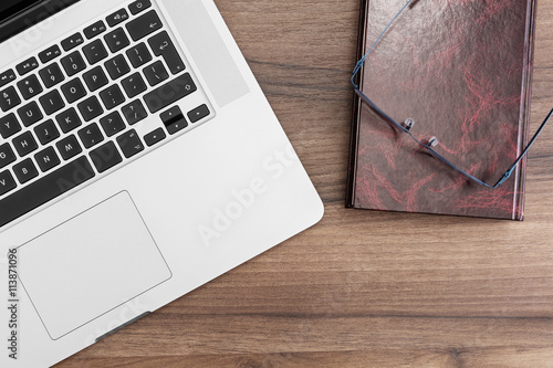 Laptop, book and glasses