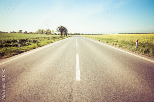 Road through the beautiful yellow field countryside landscape