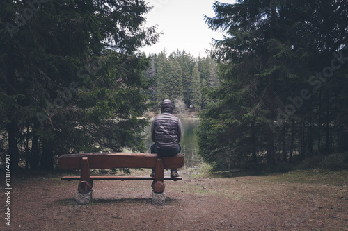 Lonely man sitting on bench