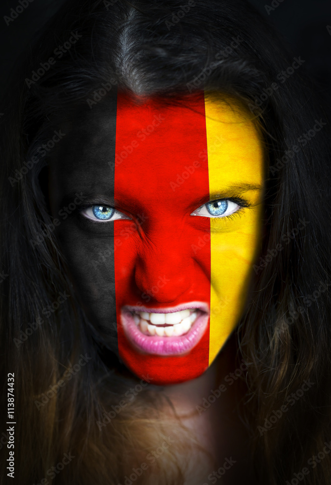 Portrait of a woman with the flag of the Germany painted on her face Portrait of a woman with the flag of the Germany painted on her face