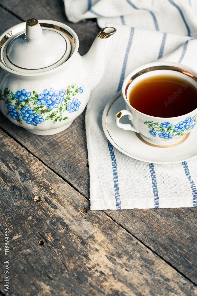 still life with tea cup and tablecloth on wooden table still life with tea cup and tablecloth on wooden table