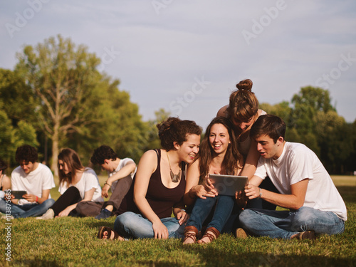 large group of friends tohether in a park having fun