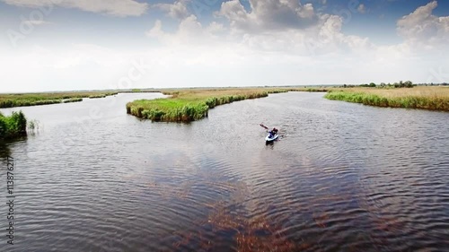 Kayaking on the river between the reeds