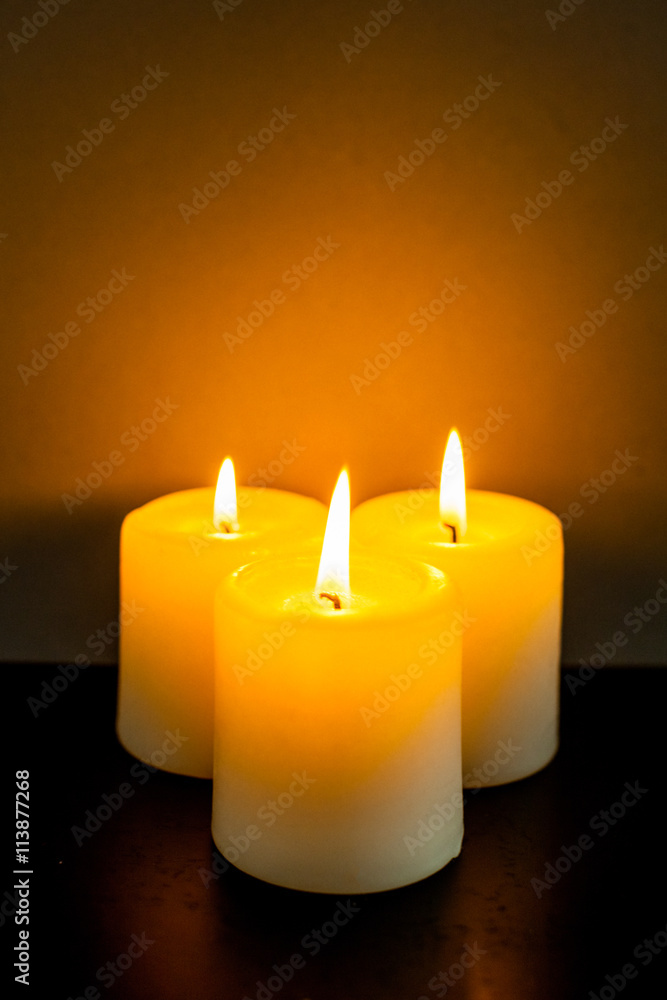 closeup to burning candles in darkness closeup to burning candles in darkness