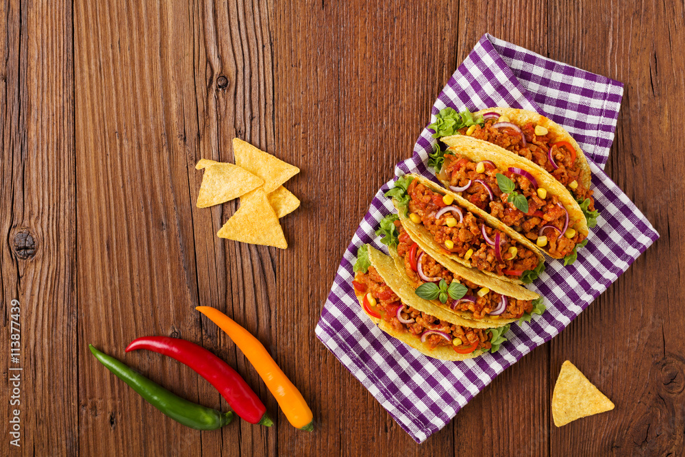Tacos with meat and vegetables on wooden board Tacos with meat and vegetables on wooden board