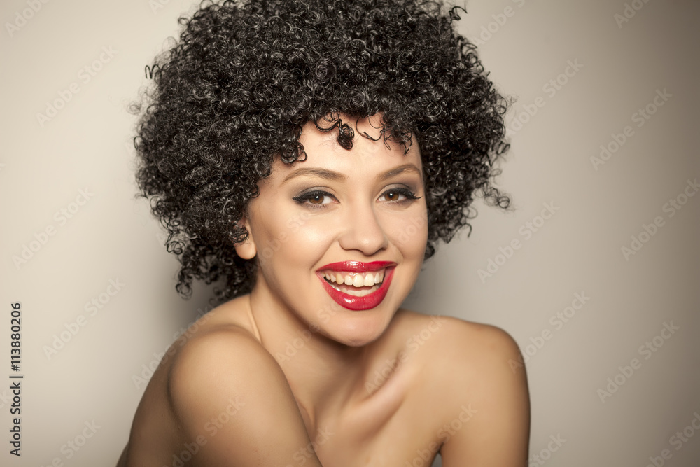 beautiful smiling young woman with black curly wig beautiful smiling young woman with black curly wig