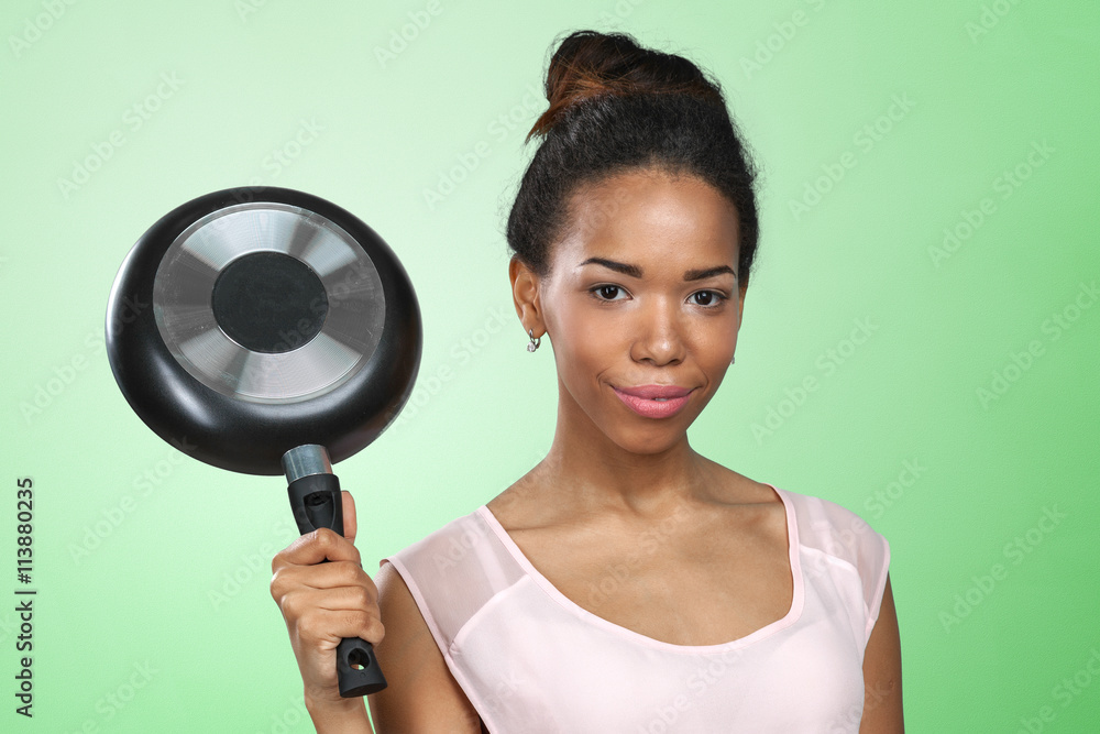 African american woman holding kitchen utensils African american woman holding kitchen utensils