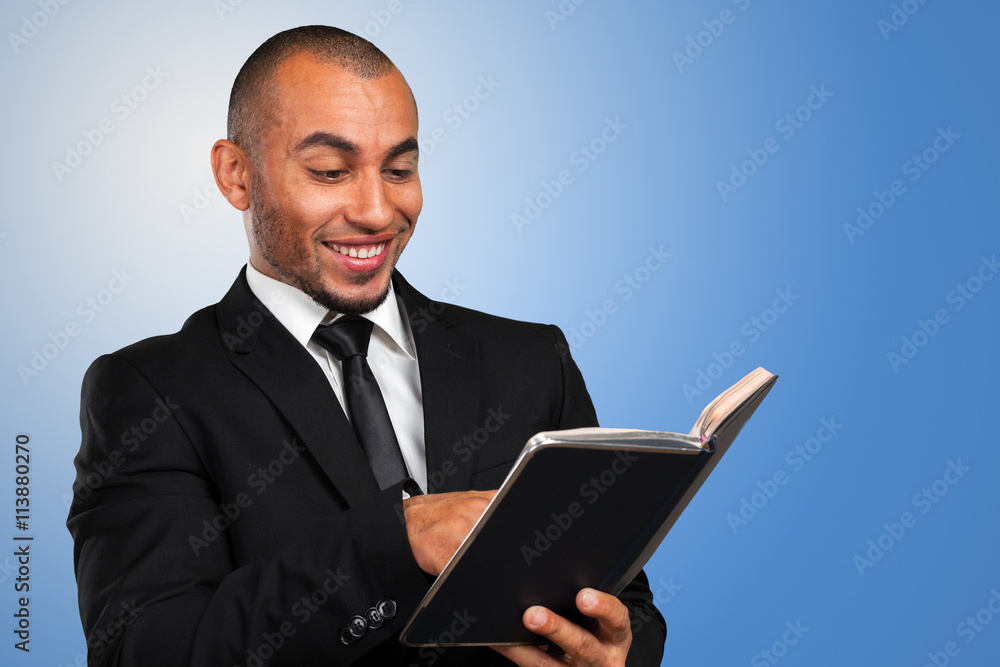 business black man holding a book