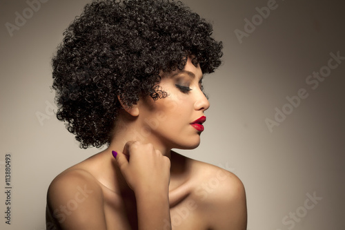 beautiful young woman with black curly wig photo