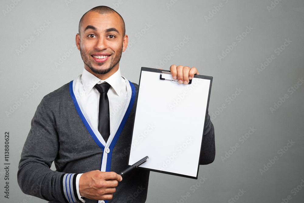 Happy successful businessman pointing on copy space