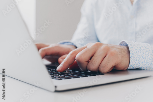 Businessman at work. Close-up top view of man working on laptop