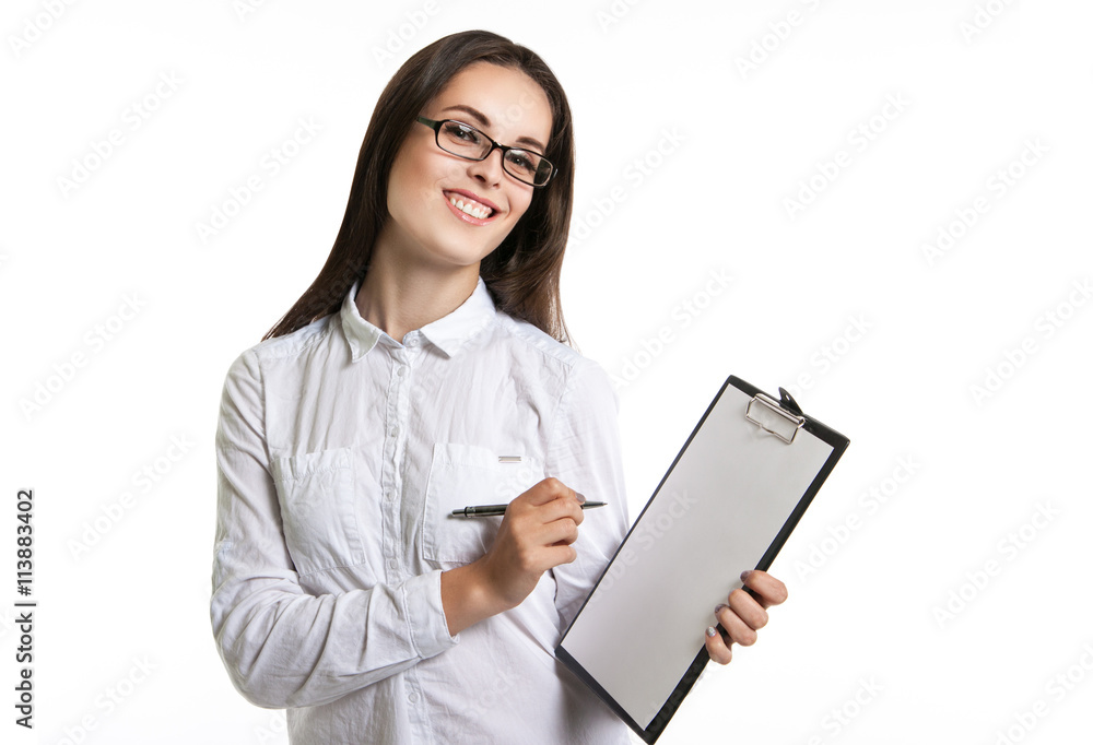 Joyful beautiful woman with a clipboard in his hands. Long-haired brunette in glasses and a white shirt. The woman points to the clipboard Joyful beautiful woman with a clipboard in his hands. Long-haired brunette in glasses and a white shirt. The woman points to the clipboard