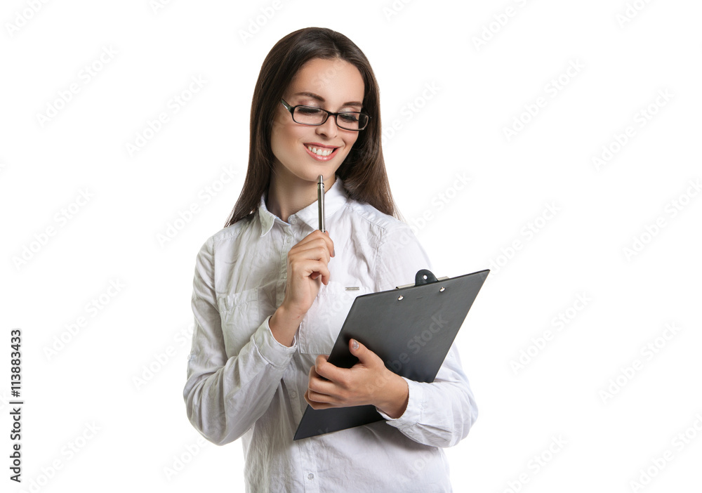 Joyful beautiful woman with a clipboard in his hands. Long-haired brunette in glasses and a white shirt. The woman points to the clipboard Joyful beautiful woman with a clipboard in his hands. Long-haired brunette in glasses and a white shirt. The woman points to the clipboard