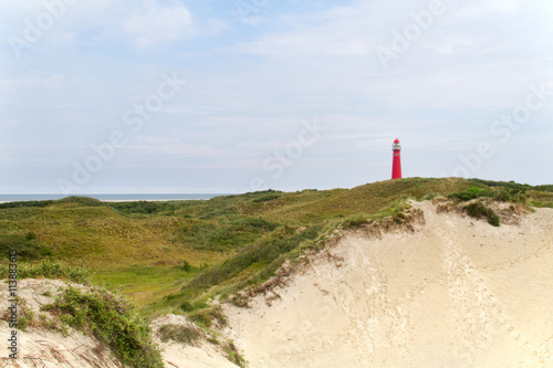 Red lighthouse in the dunes of the dutch island Schiermonnikoog