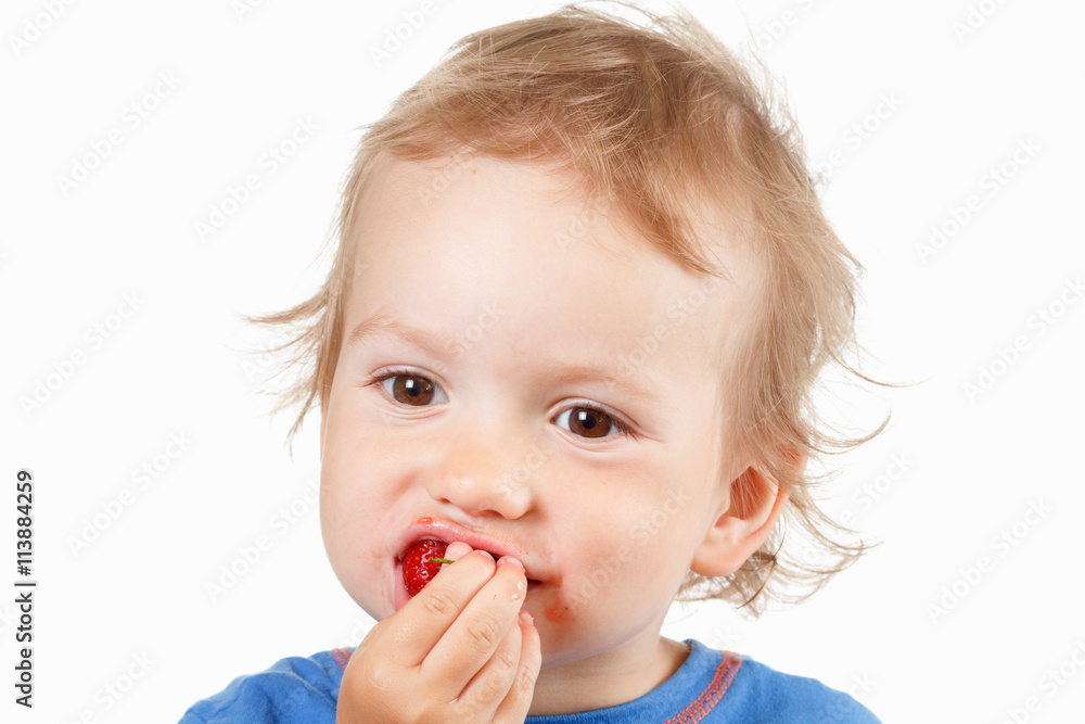 Portrait of a boy eating strawberries, on white background Portrait of a boy eating strawberries, on white background