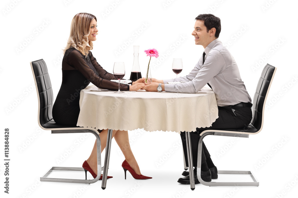 Happy couple sitting on a romantic date Happy couple sitting on a romantic date