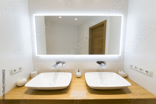 Two moderm sink in the bathroom, and big mirror