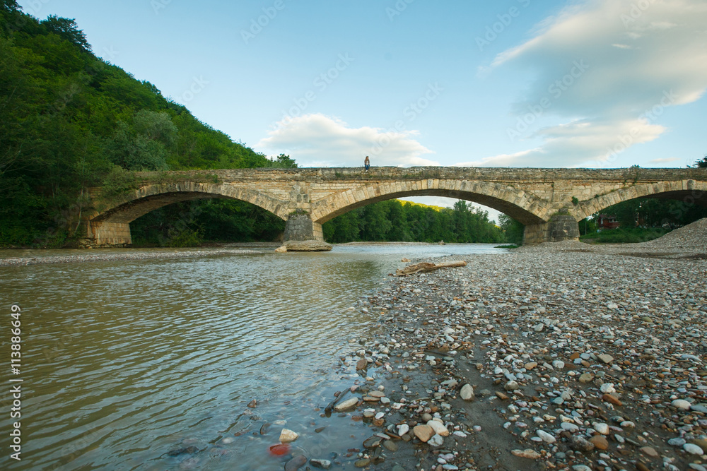 Fototapeta premium old stone bridge over Dax river, Adygea