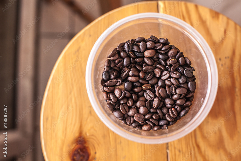 Fototapeta premium coffee beans in plastic cup 