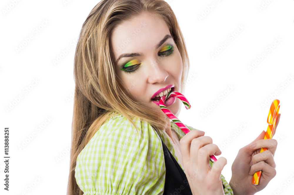 Beautiful sexy blonde girl in traditional Bavarian dress with candy isolated on a white background. Beautiful sexy blonde girl in traditional Bavarian dress with candy isolated on a white background.