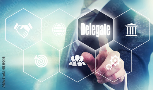 A businessman selecting a Delegate Concept button