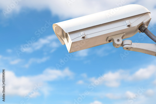 CCTV or surveillance camera  recording  important events and a guard house and property against blue sky.