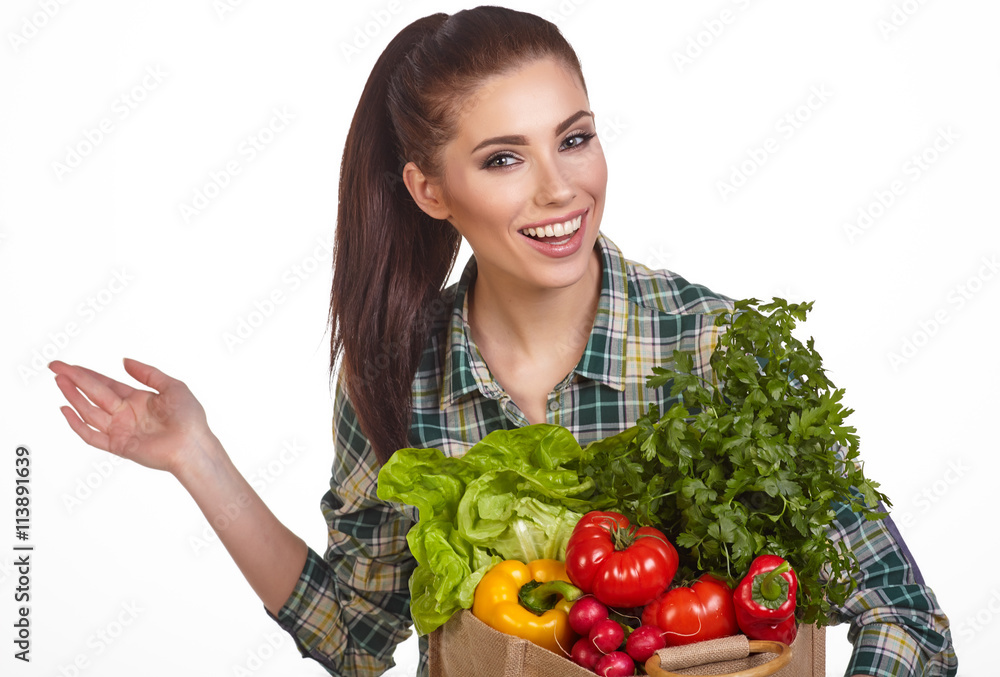 Isolated woman holding a shopping bag full of vegetables Isolated woman holding a shopping bag full of vegetables