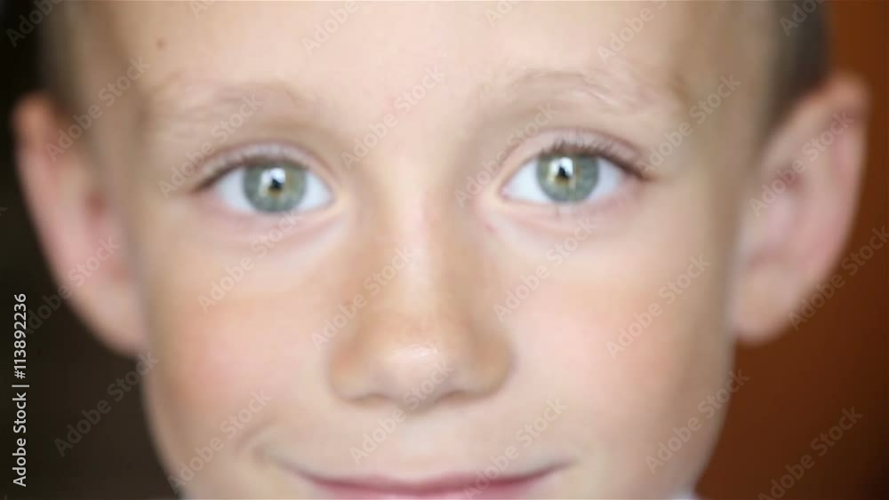 The boy looks at the camera The boy looks at the camera