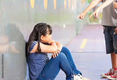 Slika na platnu Sad pupil being bullied by classmates at corridor in school